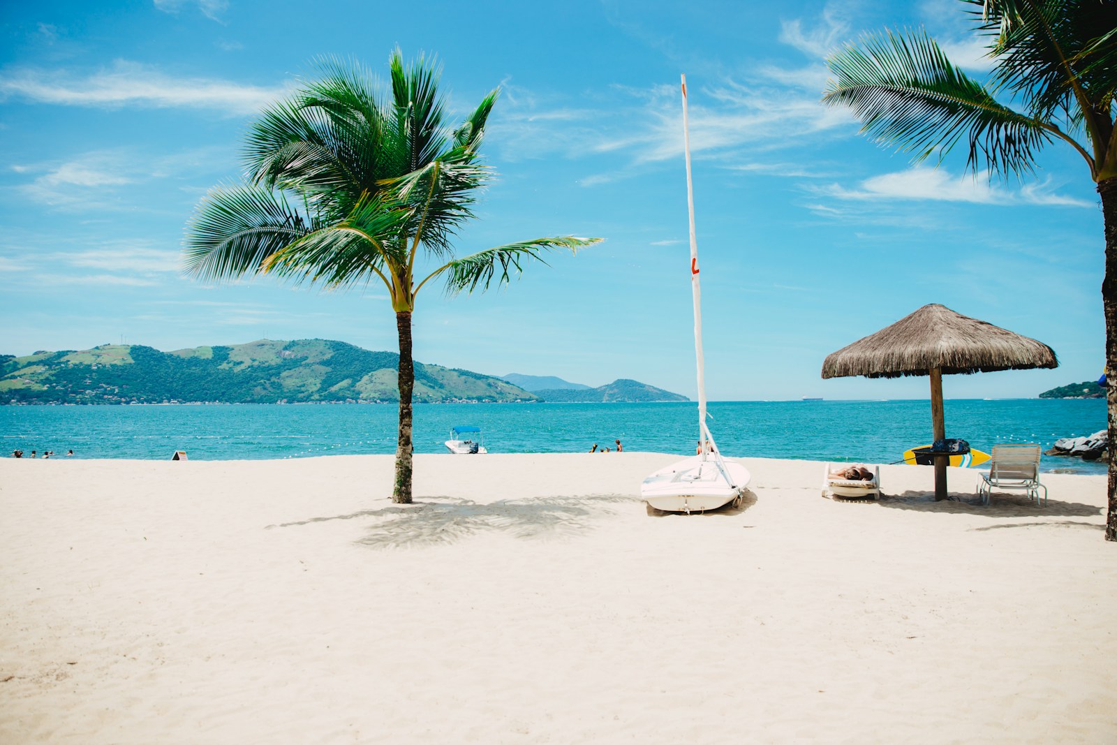 Blue water meeting a quiet tropical shoreline
